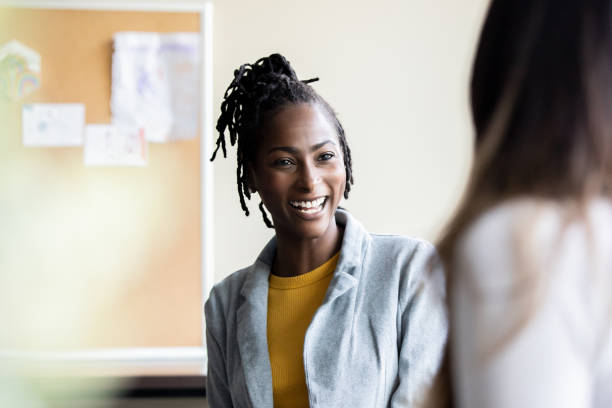 istock A high school instructor, who is a woman, oversees a group discussion with her students 1765738865