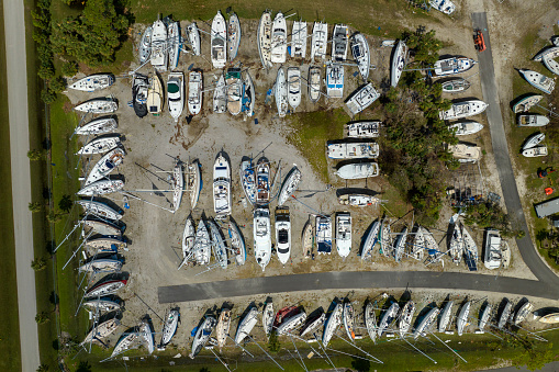 Hurricane Ian destroyed boat station in Florida coastal area. Natural disaster and its consequences.
