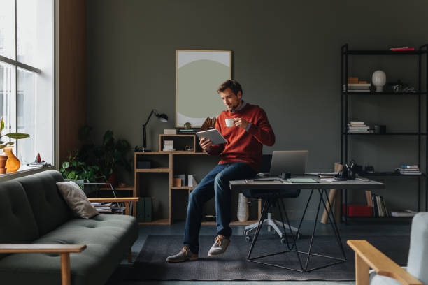 istock A Happy Handsome Businessman Using His Tablet While Working In The Office 1765761230