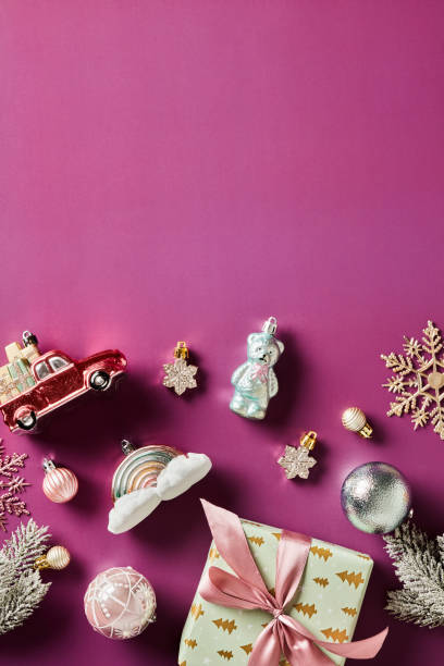 istock Vintage Christmas decorations and gift box on purple background. Flat lay, top view. 1765767960