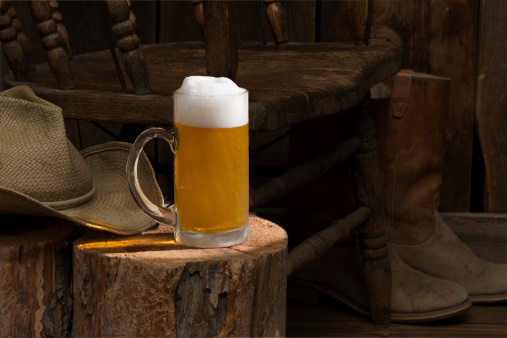 This low key image is meant to put the emphasis on the mug of beer while subduing the Western theme in the background.