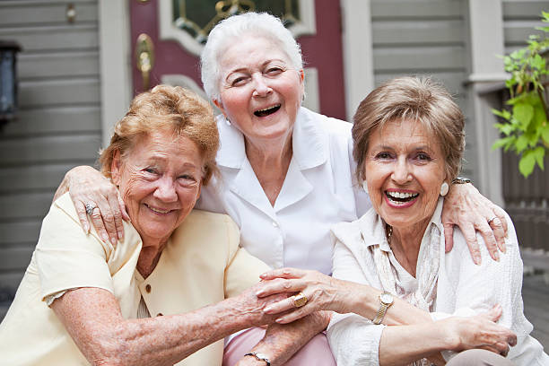 istock Three elderly women sitting in front of home 176580997