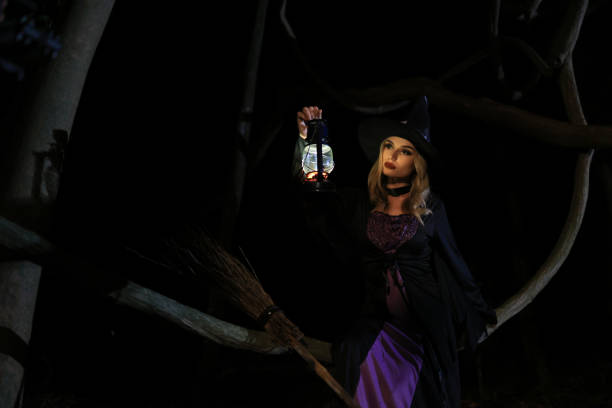 Young witch flies on a broom through the forest