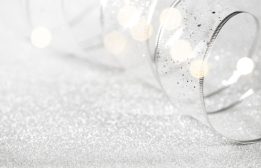 Silver holiday background with a ribbon
