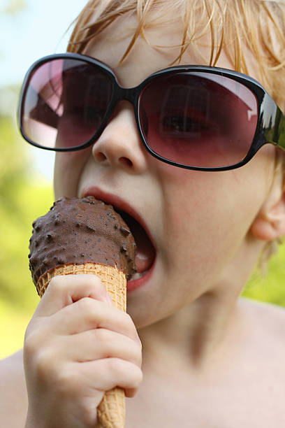istock Boy in Sunglasses Eating Ice Cream 176581795