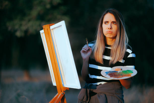 istock Frowning Woman Focused on Nature Paining in plain Air 1765822759