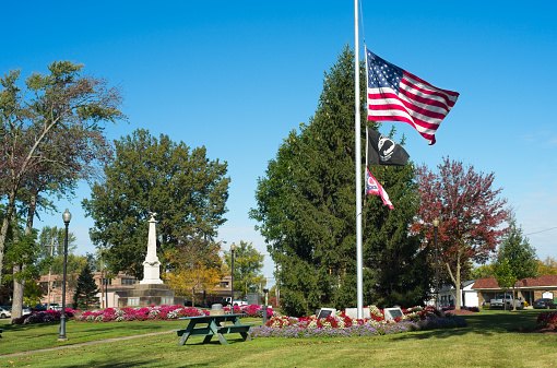An U.S. flag flies at half staff in the midst of the town square in Twinsburg, Ohio