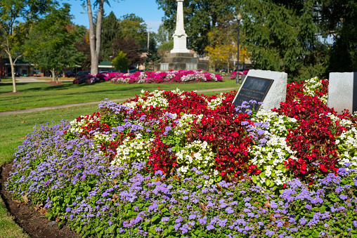 Colorful flowerbeds surround memorials on the town square in Twinsburg, Ohio