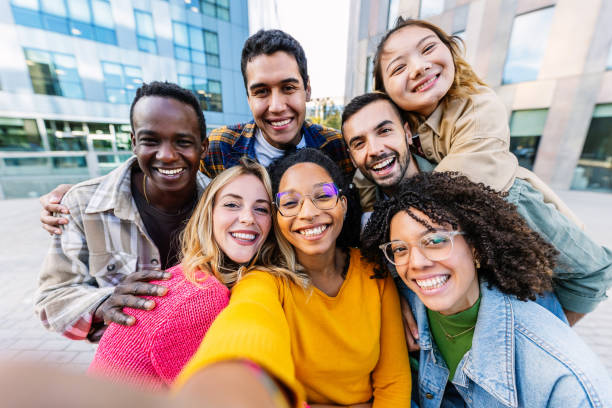 istock Diverse student group enjoying time together taking selfie with phone outdoors 1765826000