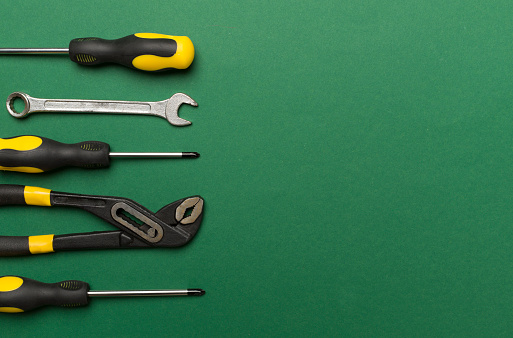 Set of tools on color background, top view