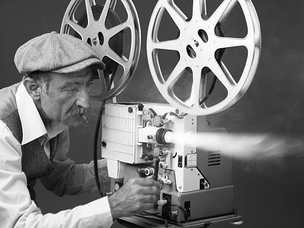 senior man projectionist は、「オールドファッションドフィルム映写機 - projectionist ストックフォトと画像