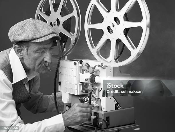 Senior Man Projectionist Starting Film With Old Fashioned Film Projector Stock Photo - Download Image Now