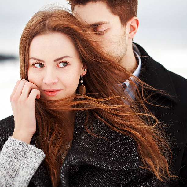 Young couple outdoor sensual portrait in cold windy weather stock photo