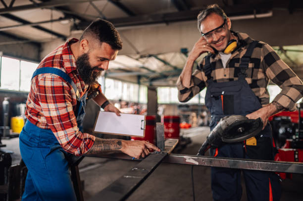 istock Colleagues working together and marking metal plate before grinding. 1765841200