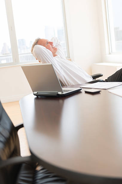 istock Businessman With Hands Behind Head Relaxing At Desk 176584411