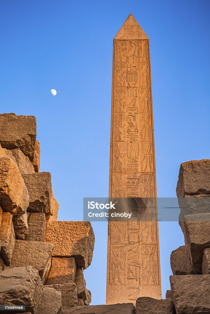 Obelisk of Hatshepsut - Karnak Temple Complex The Obelisk of Hatshepsut by sunset with moon. It is the tallest obelisk still standing in Egypt and one of two still standing at Karnak. It is 97 feet high, and is 320 tons of solid Aswan granite. Obelisk Stock Photo
