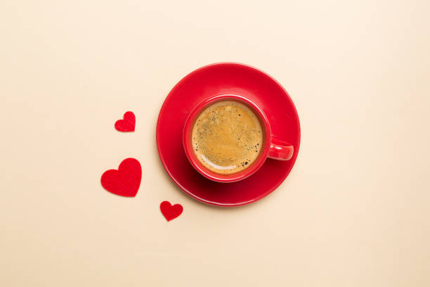 istock Red cup of coffee with hearts on color background, top view 1765845030