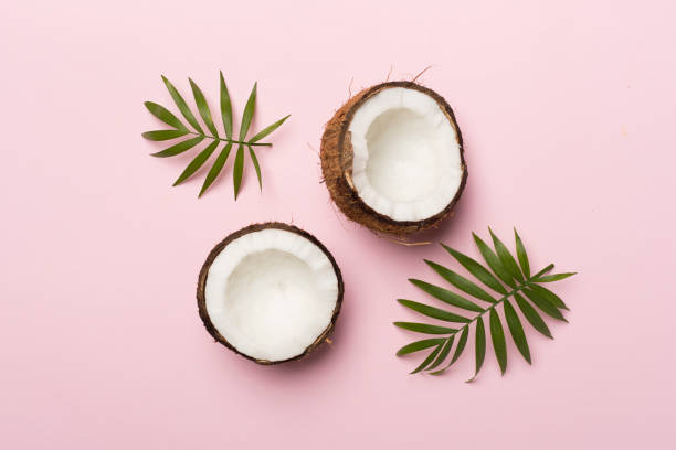 istock Coconut with leaves on color background, top view 1765857281