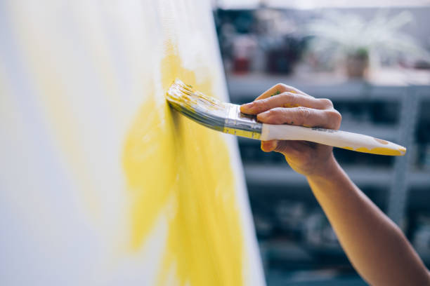 istock Hands of Creativity: Artist's Touch with Brush and Palette 1765861609