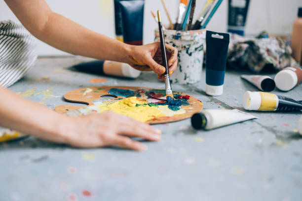 istock Hands of Creation: Artist's Palette, Brushes, and Colors 1765861649