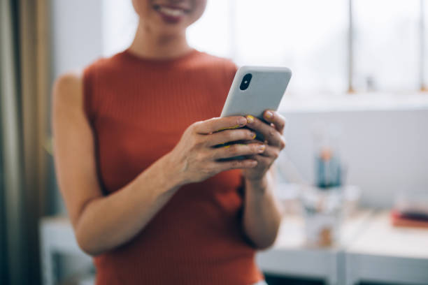 istock Anonymous Woman Artist Using Mobile Phone at Her Studio 1765862759