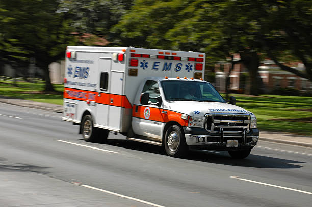 Rushing Ambulance A speeding emergency medical services ambulance, with motion blur ambulance stock pictures, royalty-free photos & images