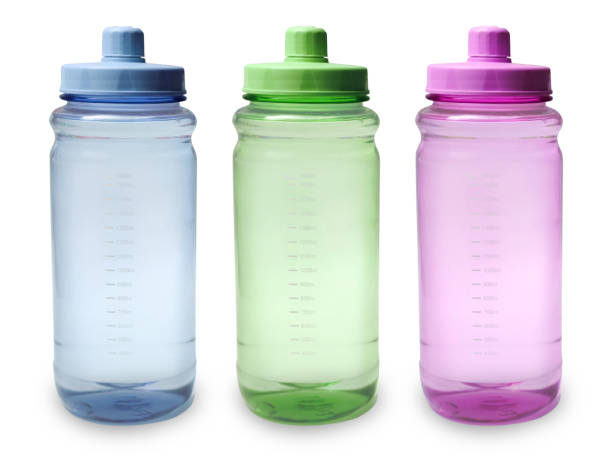 Baby girl drinks water from a water bottle with a straw