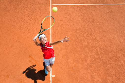 Female tennis player serving. Focus on face, convenient copy space