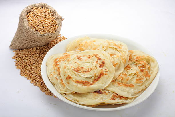 Paratha. Indian wheat paratha with The scattered bag with wheat. taftan stock pictures, royalty-free photos & images