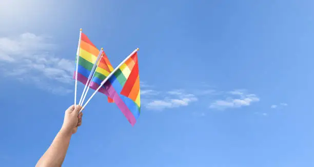 Rainbow flags, LGBT symbol, raising against bluesky, concept for celebrations and campaign of LGBTQ+ people and respect gender diversity in pride month around the world.