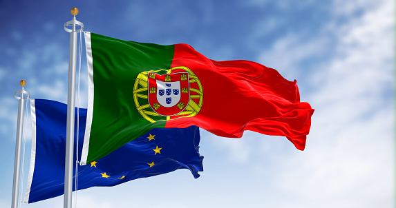 Flags of Portugal waving with European Union flags on a clear day. Democracy and politics. Rippled textile, 3d illustration render. Selective focus