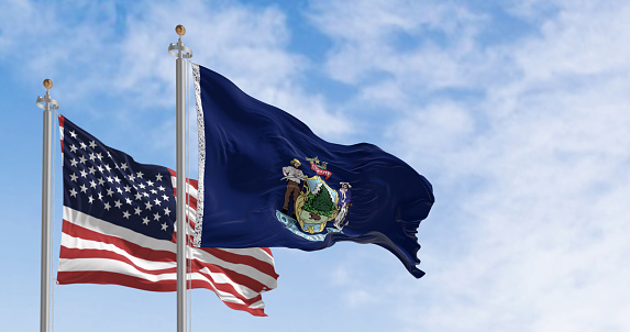 Maine state flags and the American flag waving in the wind on a clear day. State in the New England region of the northeastern United States. 3d illustration render. fluttering fabric