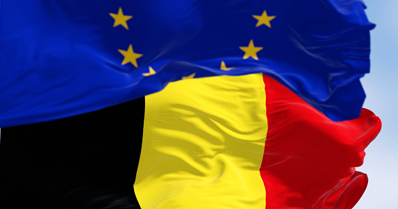 Belgium national flag and the European union flag waving in the wind. 3d illustration render. Fluttering fabric. Selective focus