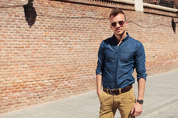 istock casual man holds hand in pocket 176593252