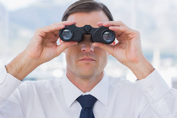 istock Close up of businessman using binoculars 176593358