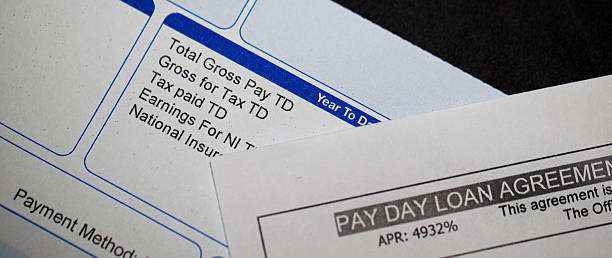 Payday loan and pay slip stock photo