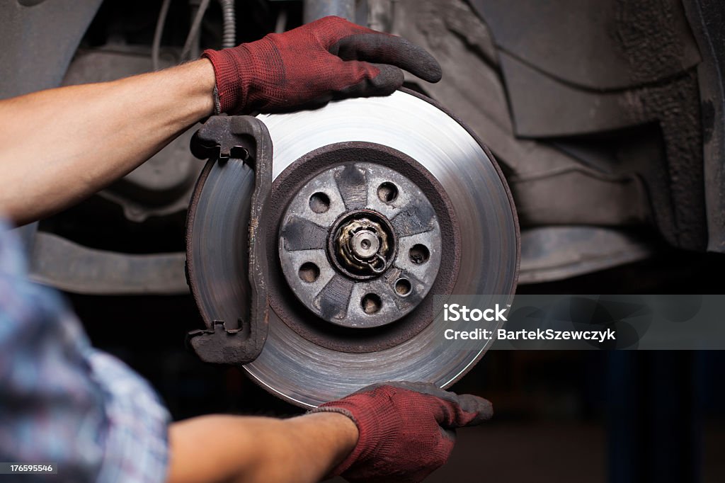 Mechanic repairing brakes on a car Repairing brakes on car Brake Stock Photo