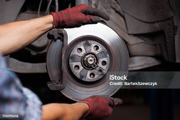Mechanic Repairing Brakes On A Car Stock Photo - Download Image Now - Brake, Brake Disc, Car