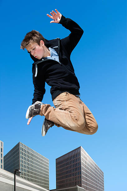istock Energetic boy jumping in city. 176596299