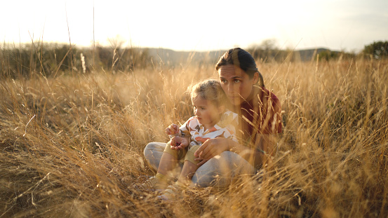 Family in nature having fun in the autumn sunset light.