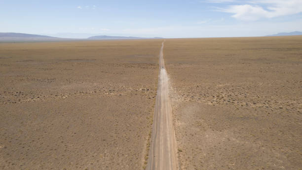 istock A white SUV is driving fast on a dusty road. Drone 1765965987