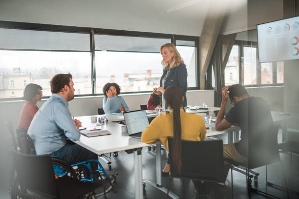 istock Through Window Shot of Disabled Man and Team Brainstorming 1765977690