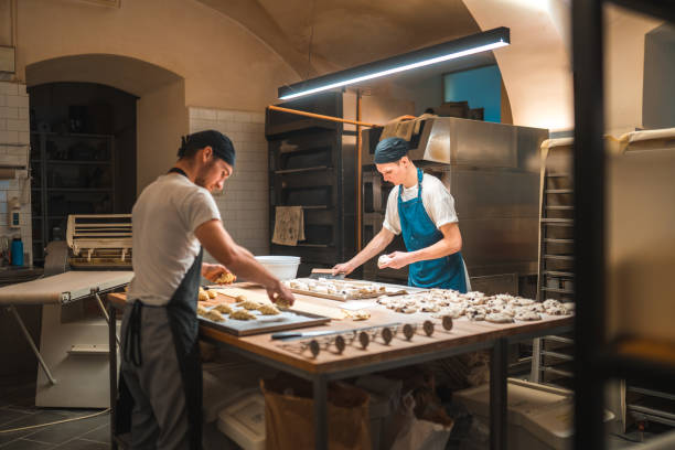 istock Caucasian Artisan Bakers Setting Pastries On A Baking Tray 1765978624