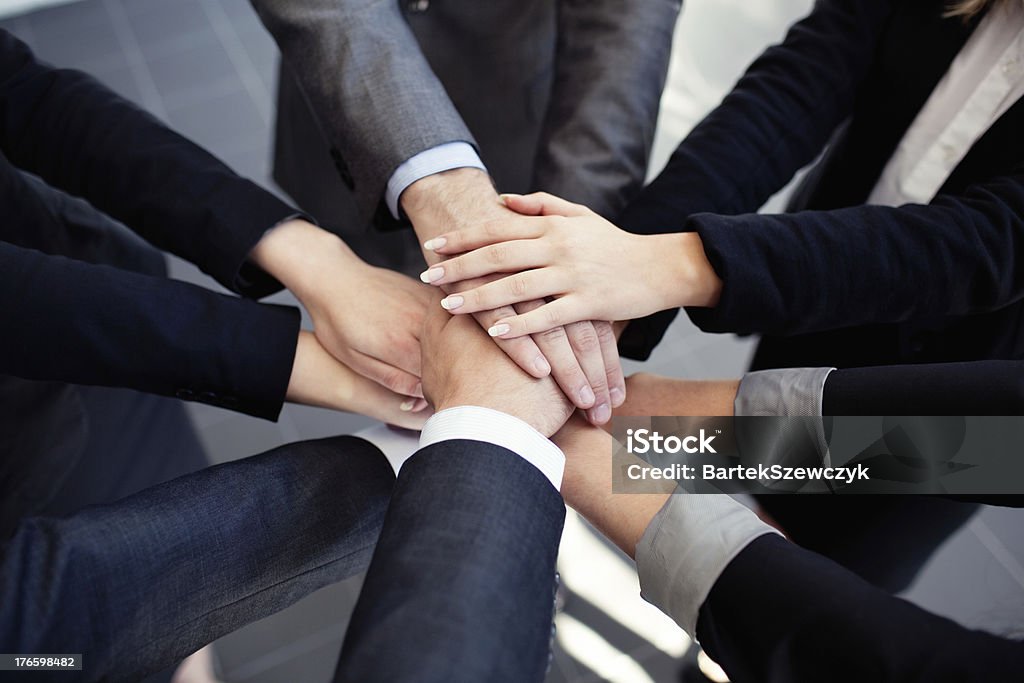 Business people joining hands Group of business people joining hands. Growth Stock Photo