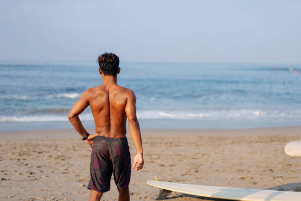 Group of Multicultural Friends Surfing in Canggu Beach Bali