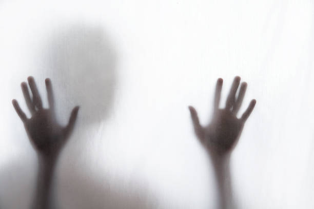 istock Shadow of man standing behind thin fabric 176600489
