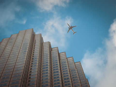 Airplane flying over a Financial Center building in Miami.