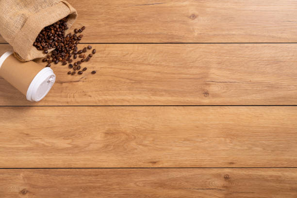istock A coffee cup takeaway and many coffee beans on a wooden table 1766042995