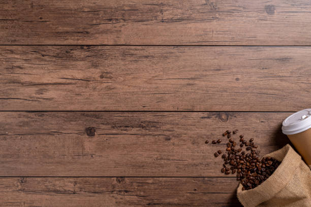 istock A coffee cup takeaway and many coffee beans on a wooden table 1766044104
