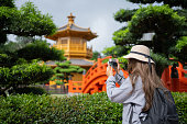 Asian tourist  woman  are traveling in Hong Kong with map and her camera